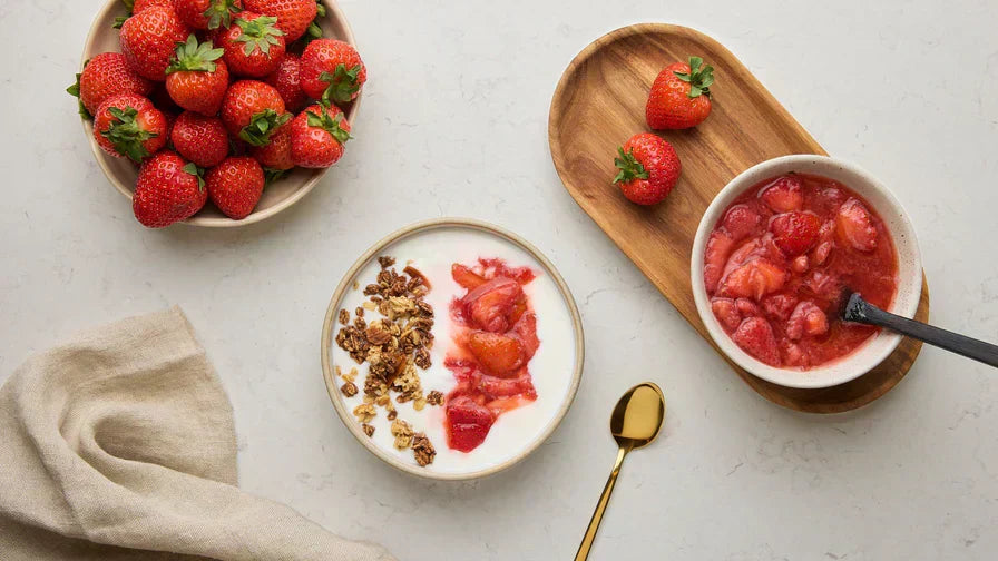 Fresh strawberries in a jar with honey ready to ferment
